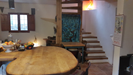 Oak breakfast bar leading to the cosy open plan lounge, log fire and oak spiral staircase